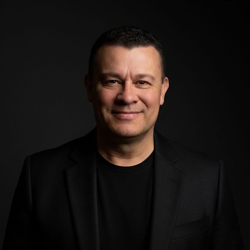 Portrait of Dave Espino, entrepreneur and marketing scientist, in a black blazer